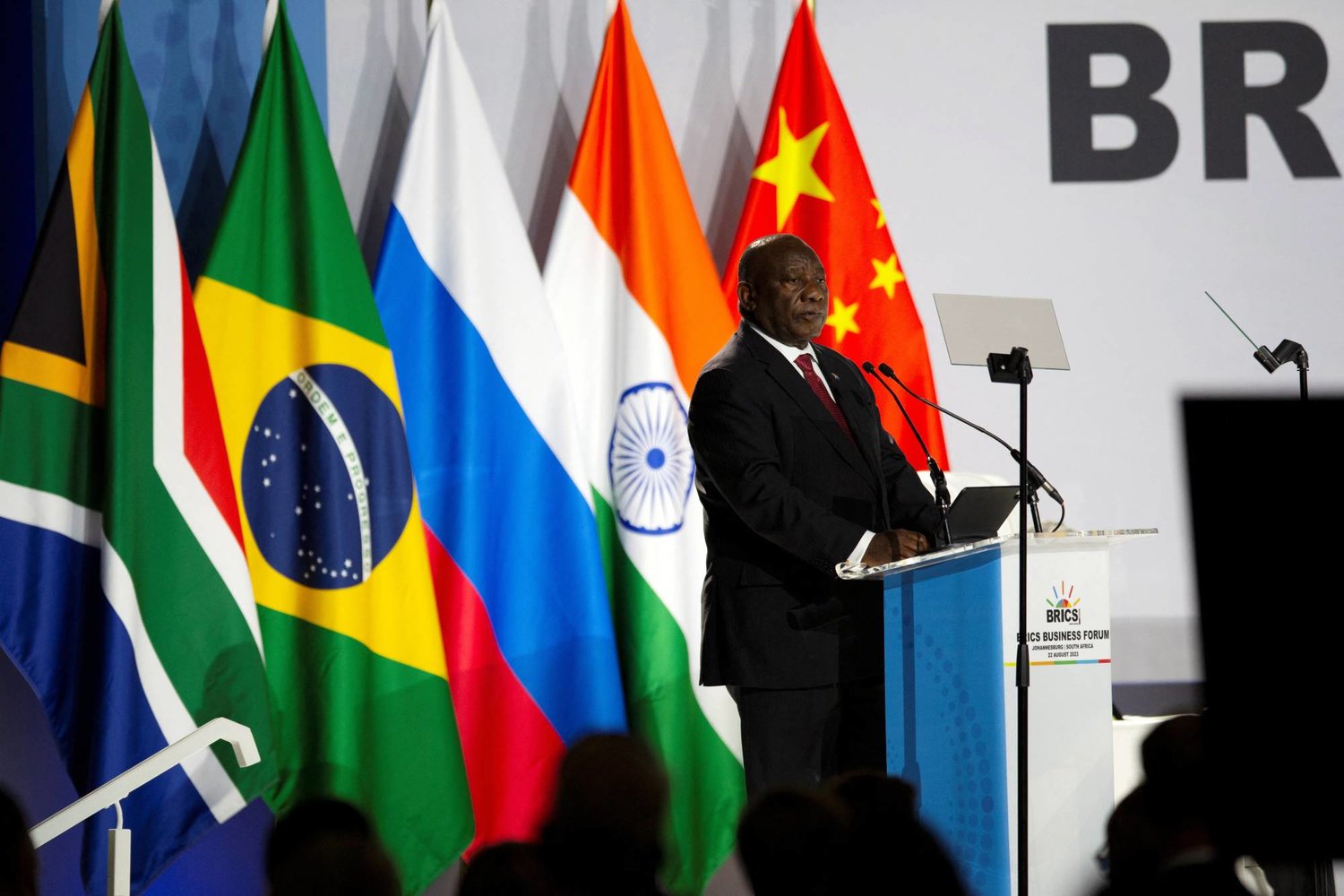 President Cyril Ramaphosa addressing the BRICS Business Forum before the founding member flags